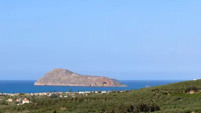 a view of a small island in the ocean at Blue Zone Villa, a SeaView Sanctuary with Pool, By ThinkVilla in Chania Town