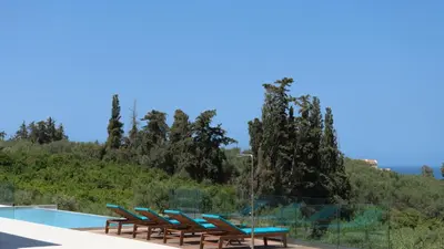a pool with chairs and a table and a swimming pool at Blue Zone Villa, a SeaView Sanctuary with Pool, By ThinkVilla in Chania Town