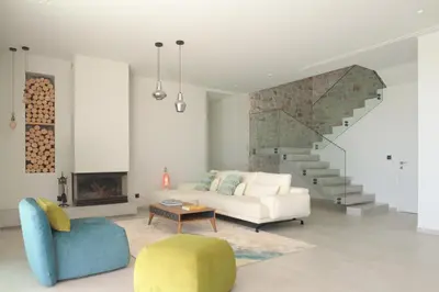 a living room with a couch and a staircase at Blue Zone Villa, a SeaView Sanctuary with Pool, By ThinkVilla in Chania Town