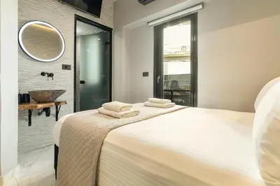 a bedroom with a large bed with a mirror on the wall at Melina's - Urban Luxury 2-Bath Apt with 2 Balconies - Heart of Chania in Chania Town