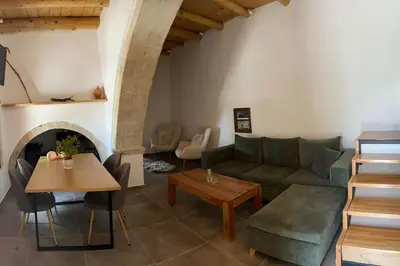 a living room with a couch and a table at Vrysses Lodge Michael Stelianos in Vryses