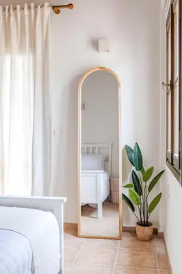 a bedroom with a mirror in front of a bed at The Yard Residence in Gavalochori
