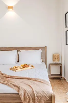 a bed with a tray of food on it at The Yard Residence in Gavalochori