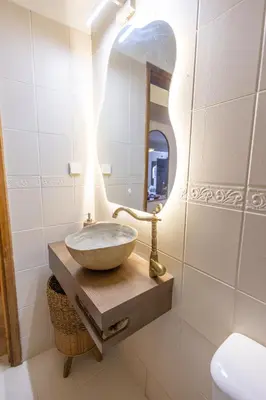 a bathroom with a bowl sink and a mirror at The Yard Residence in Gavalochori
