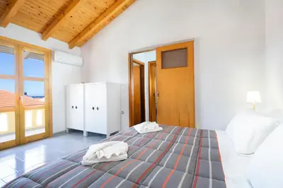 a bedroom with a bed with two towels on it at Eleni Residences in Kalyves
