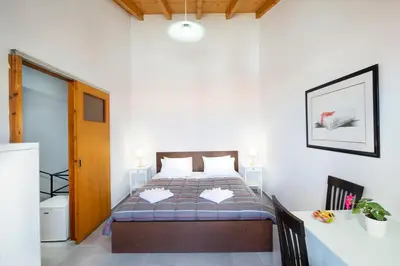 a bedroom with a bed and a desk in it at Eleni Residences in Kalyves