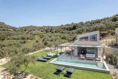 an aerial view of a house with a swimming pool at Seaview villa with pool in nature next to Platanias in Plataniás