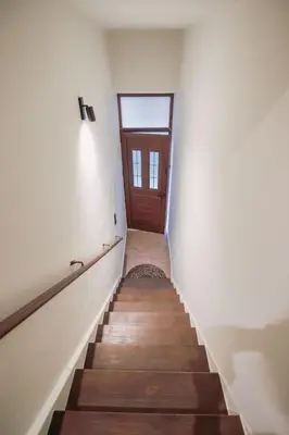 a hallway with a staircase with a wooden door at Santa Lucia - Cozy City Studio in Central Chania in Chania Town