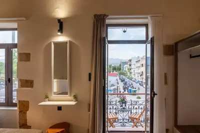 a room with a window and a view of a street at Santa Lucia - Cozy City Studio in Central Chania in Chania Town