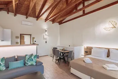 a bedroom with a bed and a couch and a table at Santa Lucia - Cozy City Studio in Central Chania in Chania Town