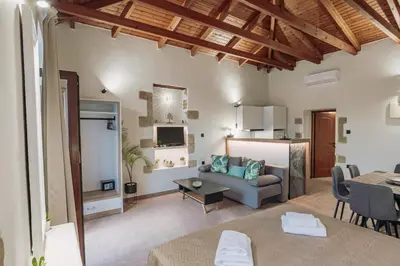a living room with a couch and a table at Santa Lucia - Cozy City Studio in Central Chania in Chania Town