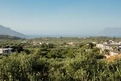 a view of a town from the hills at Manolis Stone House Villa in Mouríon