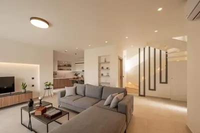 a living room with a couch and a table at Villa Icons in Agia Marina Nea Kydonias