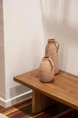 two vases sitting on top of a wooden table at Qualia Slowlife Suites in Chania Town