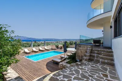 a backyard with a swimming pool and a house at Naruto Villas in Kissamos