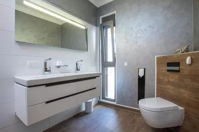 a bathroom with a white sink and a toilet at Naruto Villas in Kissamos
