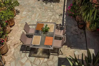 an overhead view of a table with chairs and plants at Harbour Studios And Apartments in Palaiochóra