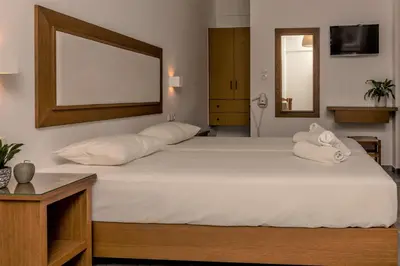 a bedroom with two white pillows on a bed at Harbour Studios And Apartments in Palaiochóra