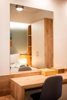 a room with a desk with a mirror and a bed at Clio - Newly renovated Home with Parking in Chania Town