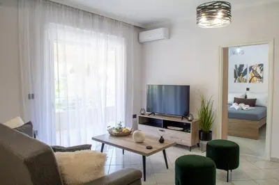 a living room with a couch and a tv at Benessere in Chania Town