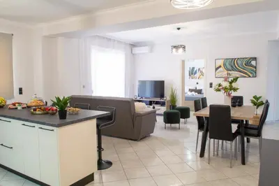 a kitchen and living room with a couch and a table at Benessere in Chania Town