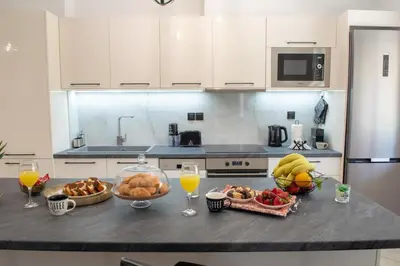 a kitchen counter with a bunch of fruit and drinks at Benessere in Chania Town