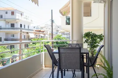 a balcony with a table and chairs on it at Benessere in Chania Town
