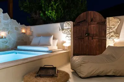 a bedroom with a tub and a chair and a bed at Delta-Rho in Kalami