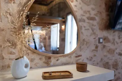 a white vase sitting on a counter with a mirror at Delta-Rho in Kalami