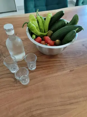 a bowl of vegetables and a bottle of water on a table at Anatoli Apartment in Kissamos
