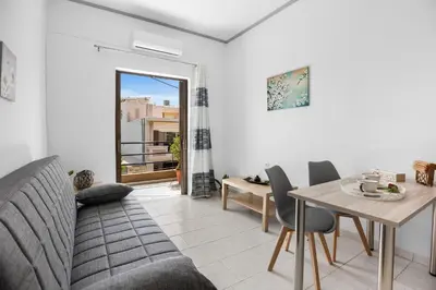 a living room with a table and a dining room at Seafront Apartment in Chania 7 in Chania Town