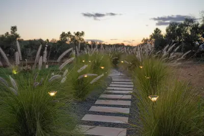 a walkway in a field with lights in the grass at Afea Villas in Plataniás