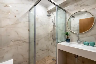 a bathroom with a shower and a sink at Modern Dream Apartment in Plataniás