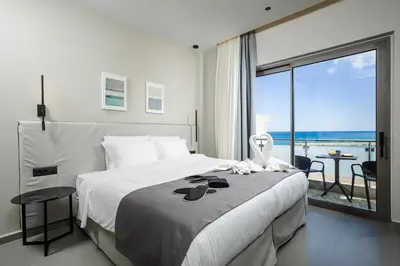 a bedroom with a bed with a view of the ocean at Iria Sea View Room in Kolymvari