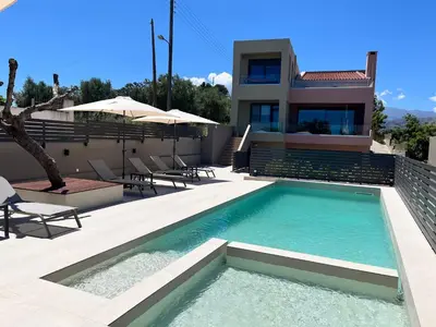 a house with a swimming pool in front of a house at Dream's House - Villa with Pool & Stunning Views in Daratso