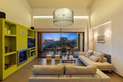 a living room with a couch and a table at Dream's House - Villa with Pool & Stunning Views in Daratso