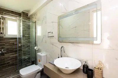 a bathroom with a toilet and a sink and a shower at Harmony Villa in Chania Town