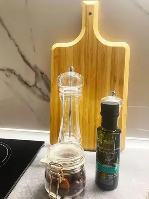a bottle of oil next to a jar of olives at Steki Luxury Room 1 in Chania Town