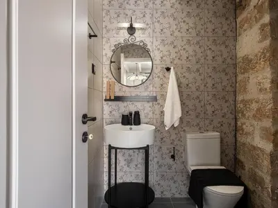 a small bathroom with a sink and a toilet at Steki Luxury Room 3 in Chania Town