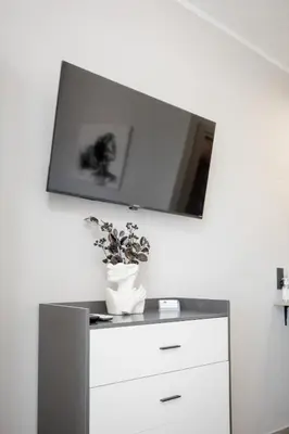 a white vase on a dresser with a mirror at Petra's Charming Home, 500m to Beach in Chania Town