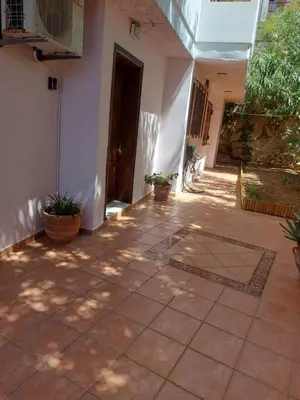 a patio with potted plants and a building at Eolia apartment in Chania with Sea&City View in Chania Town