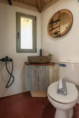 a bathroom with a sink and a toilet and a mirror at Eco Olive Treehouse in Chania Town