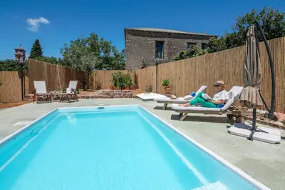 a woman laying in a chair next to a swimming pool at Eco Olive Treehouse in Chania Town