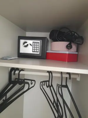 a shelf with a alarm clock and books on it at Myhope in Chania Town