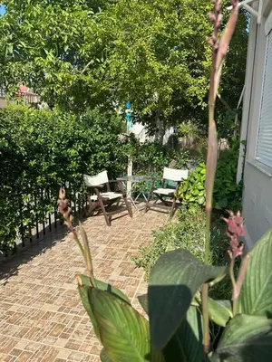 a patio with two chairs and a table and benches at Myhope in Chania Town