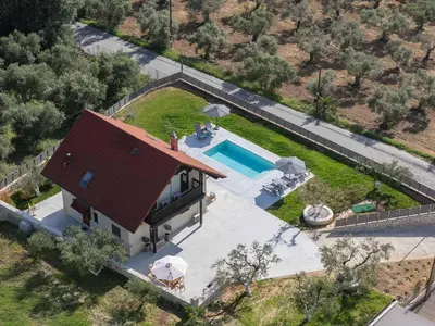 an overhead view of a house with a swimming pool at Olive Garden Villa 5 min from Golden Beach in Galatás