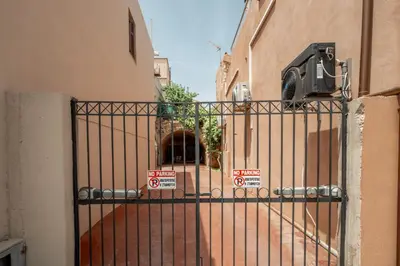 a gate with signs on it in front of a building at ARCH HOME, luxury property with private parking in Chania Town