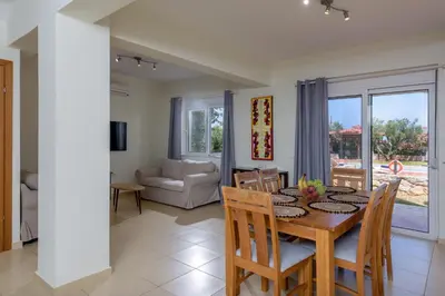 a dining room and living room with a table and chairs at Aloni Grove Retreat in Chania Town
