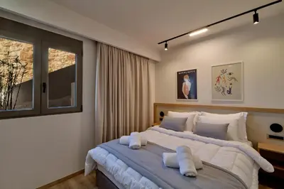 a bedroom with a large bed with towels on it at Thearia villa II private heated hydromassage pool in Souda