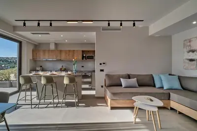 a living room with a couch and a table at Thearia villa II private heated hydromassage pool in Souda